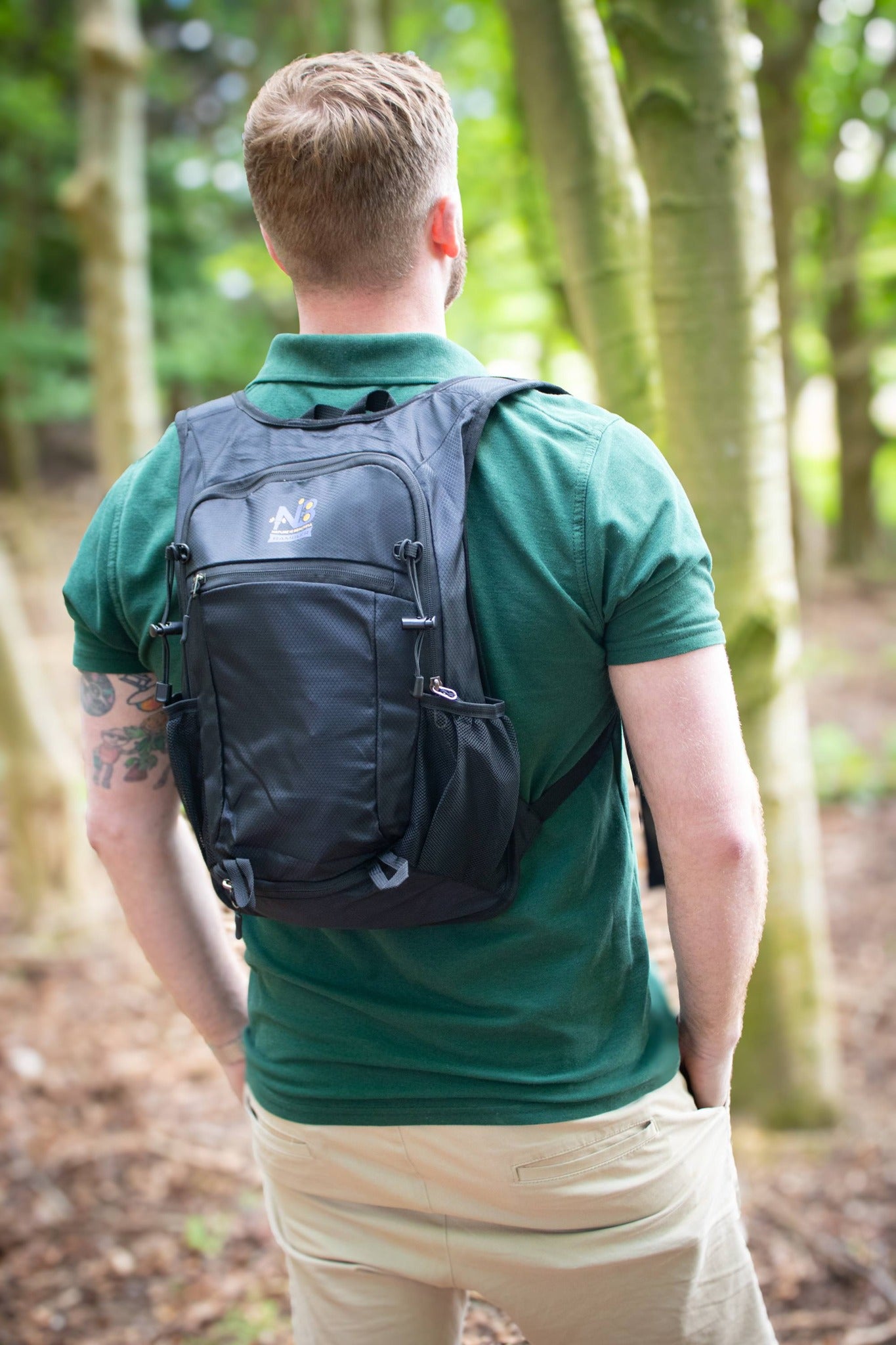 NIB Rambler black backpack worn on a woodland walk
